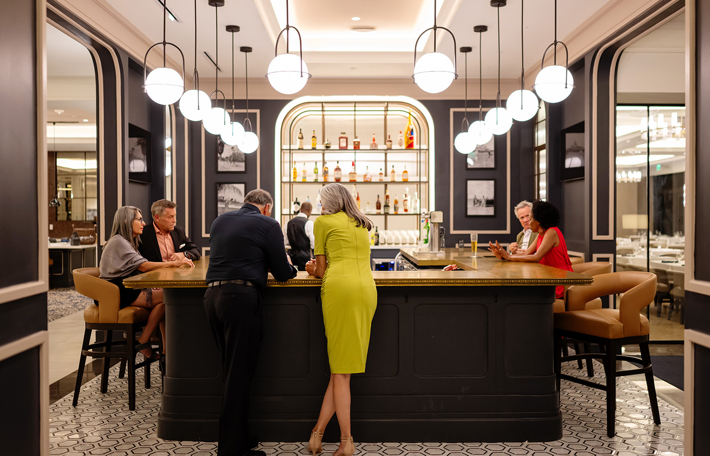 People standing by the bar.