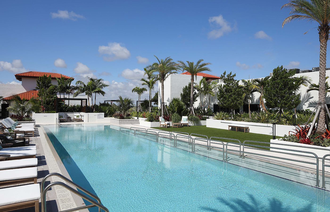 An outdoor swimming pool with lounge chairs.