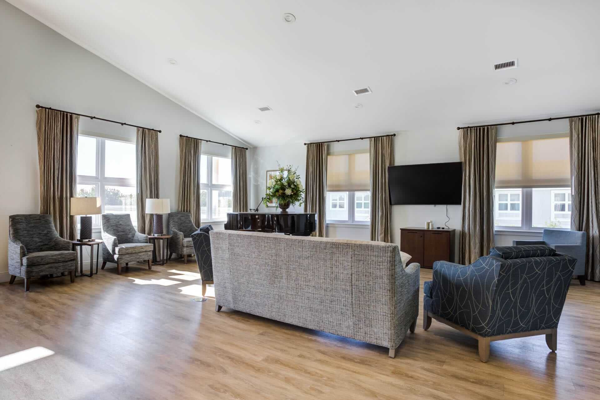 Furnished living room space with sofa, table, and seating area.