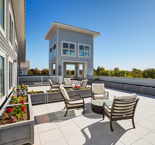 A rooftop courtyard area with planter boxes.