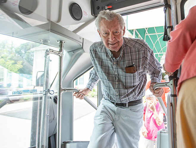 A resident get's on a bus.