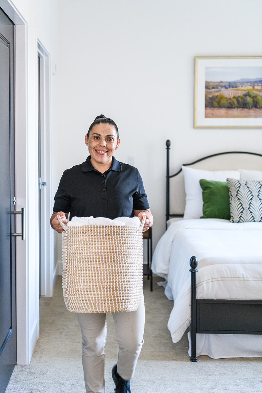 A person is holding a laundry basket.