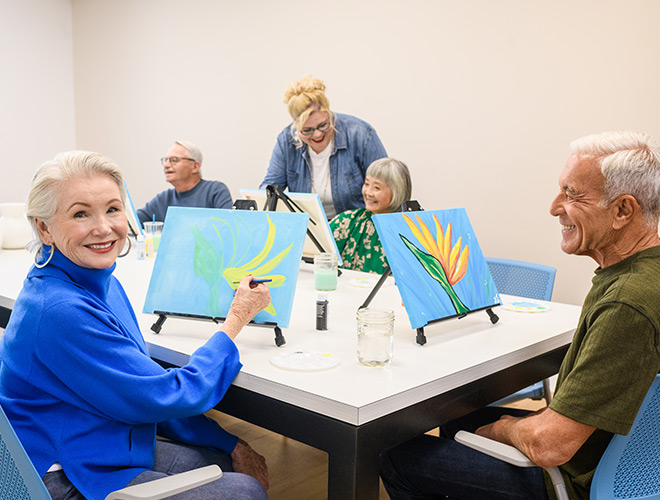 Residents are painting in an art class.