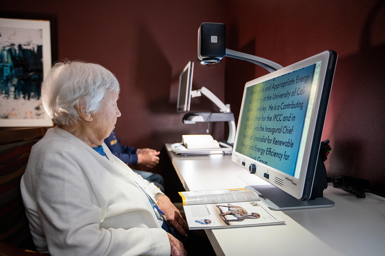 A resident sitting at desk looking at computer screen