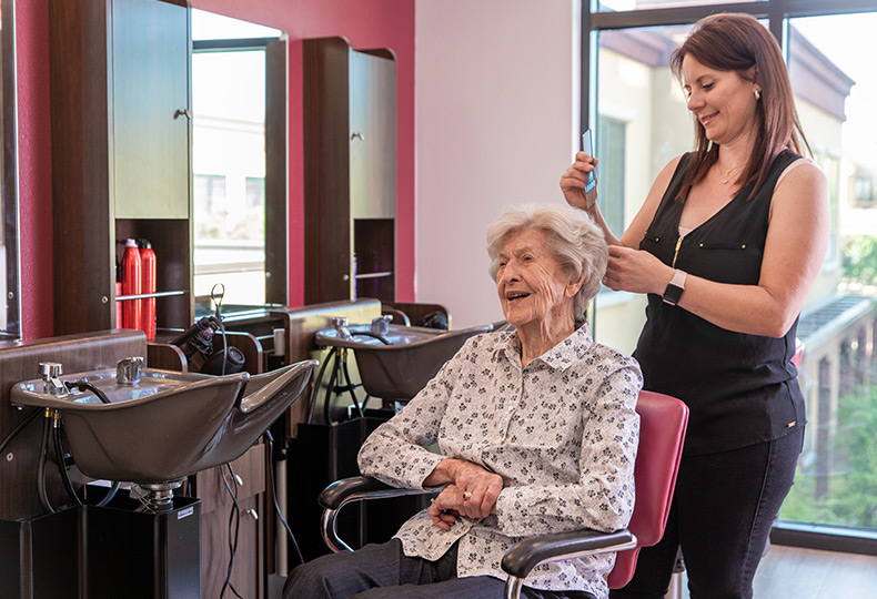 A resident is getting their hair done at the salon.