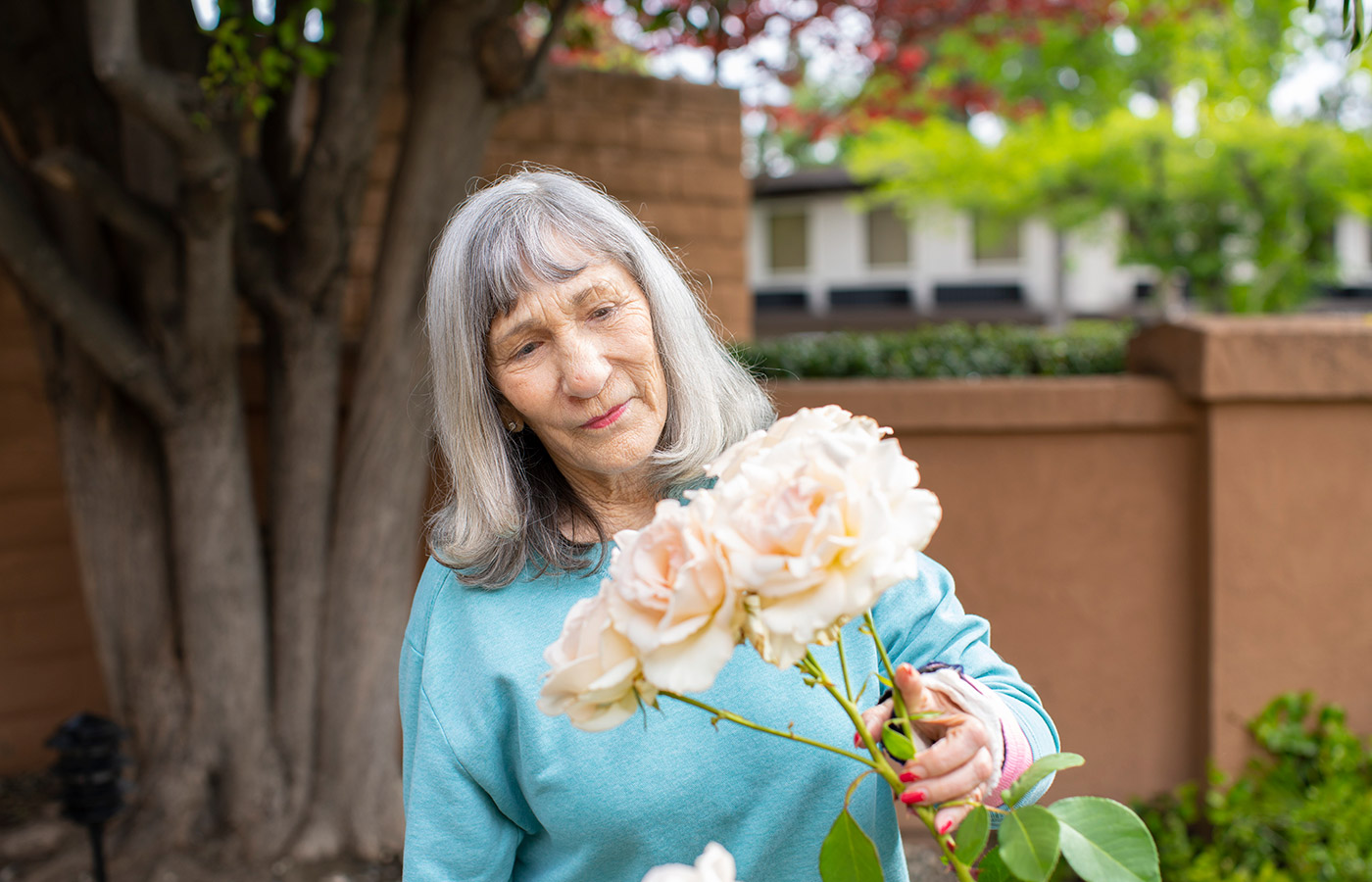 A resident is holding flowers.