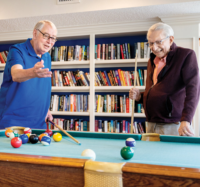 Residents enjoying a game of pool.