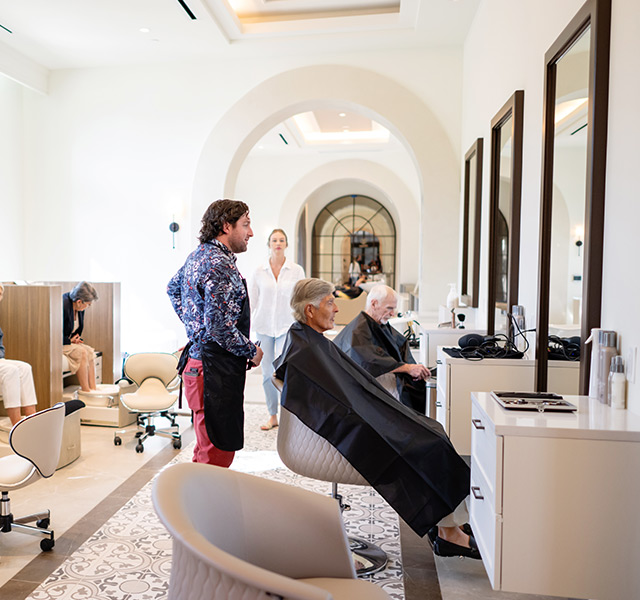 A salon with people and stylists.