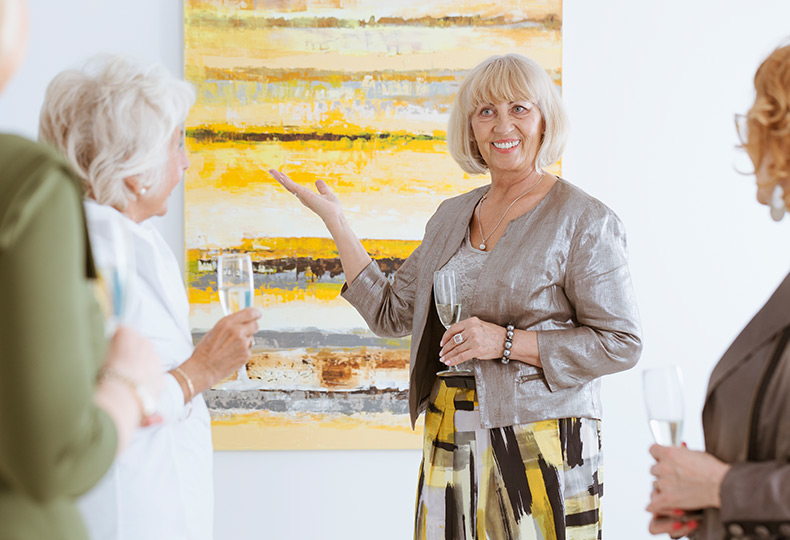 People viewing art and drinking wine.