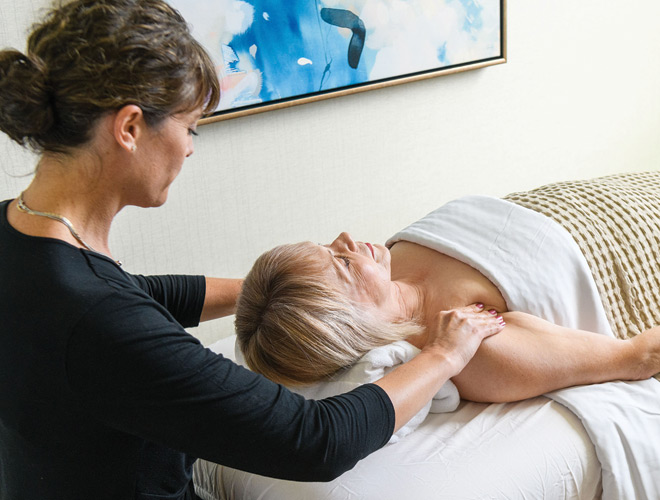 Person receiving a relaxing massage in a calm and serene setting.