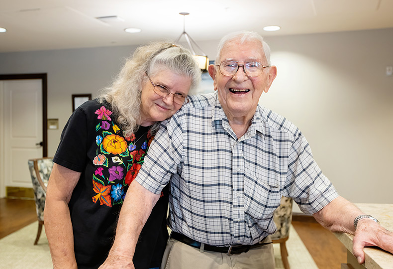 A father and daughter smiling.