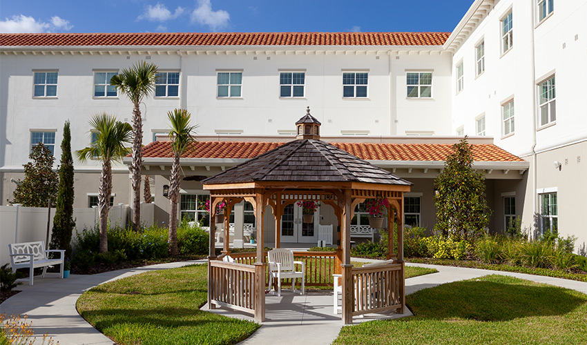 A gazebo in front of a building.