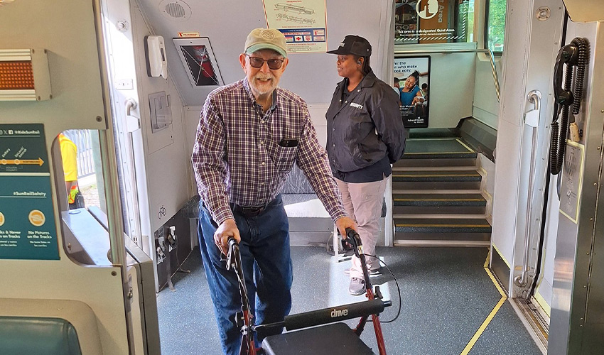 A man is walking on a train.
