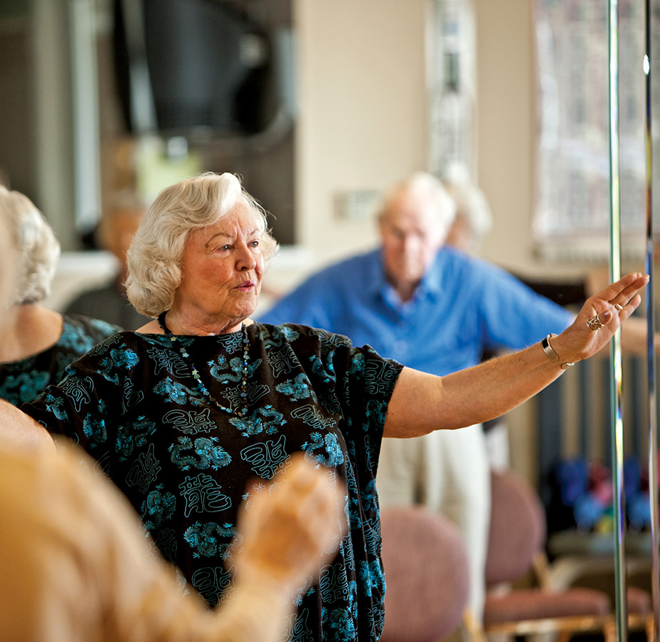 A resident is participating in a tai chi class.