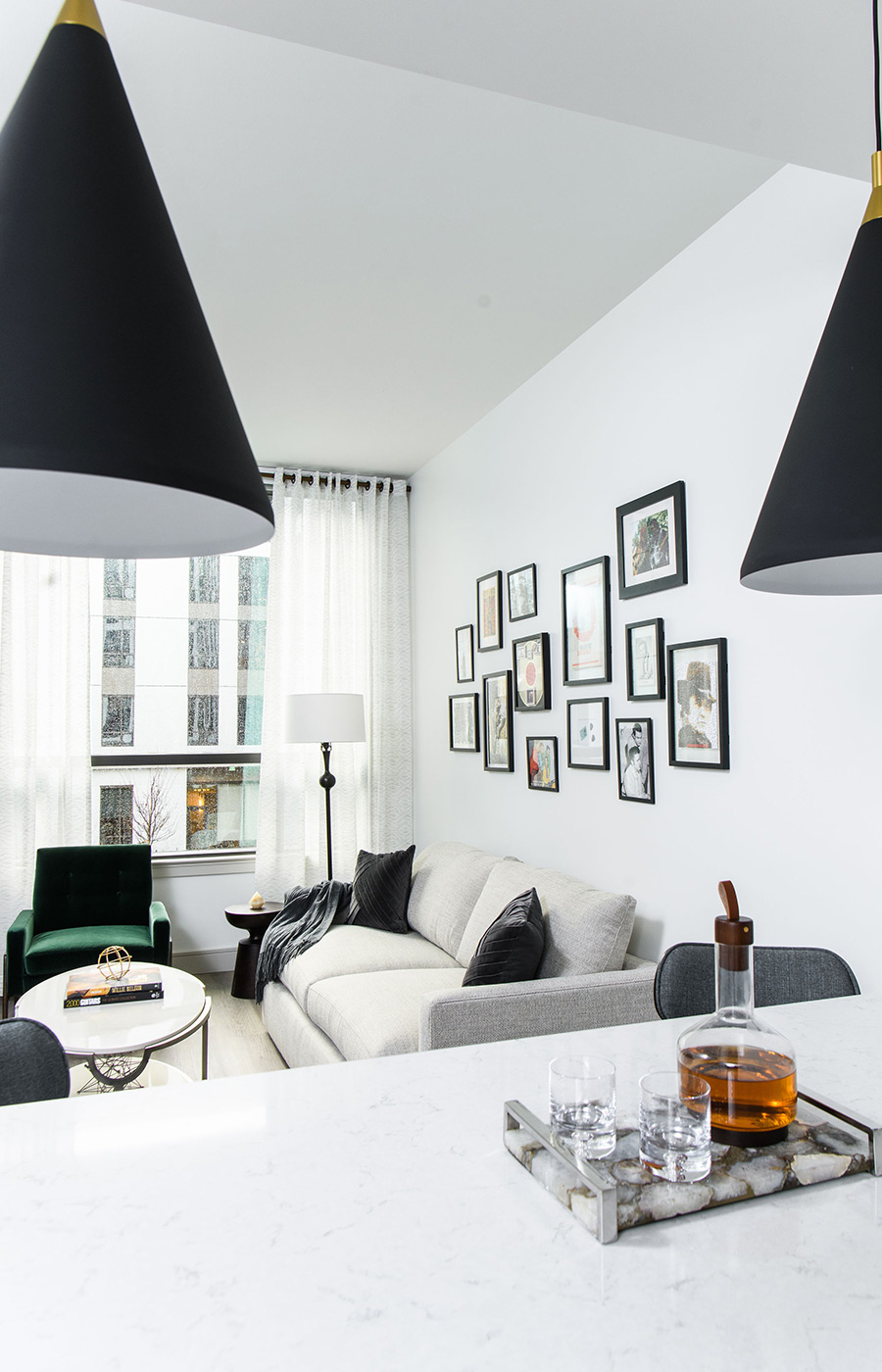 A furnished model apartment kitchen looking in to the living room.