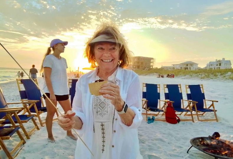 A lady is at a beach with friends. 