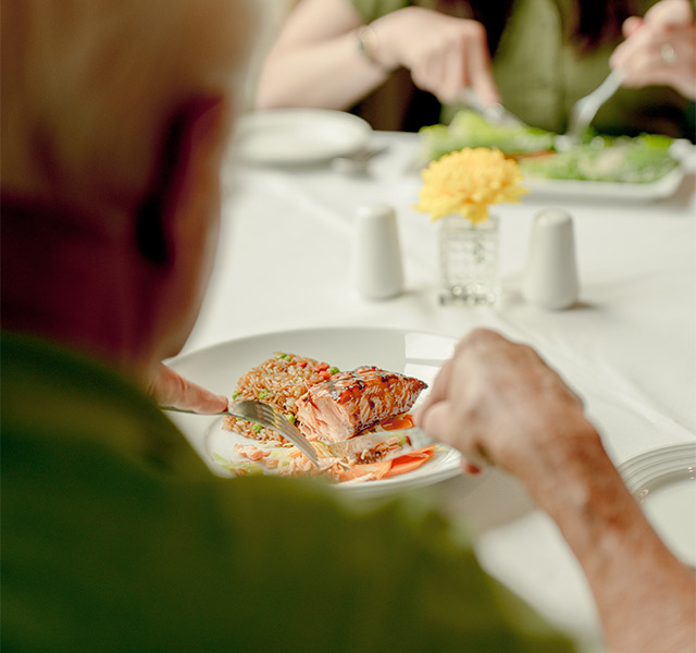 Two people eating dinner.
