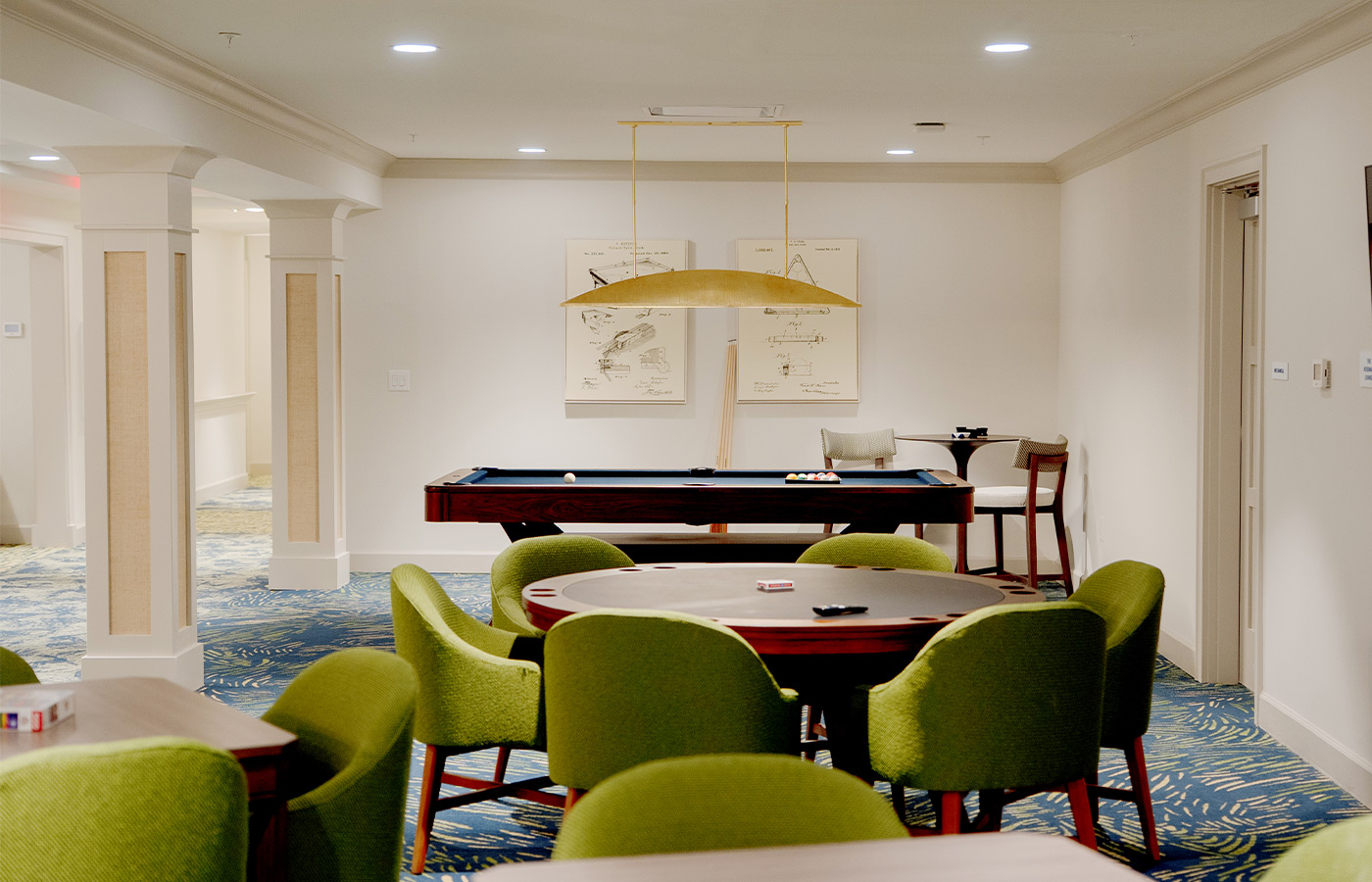A game room with a pool table.