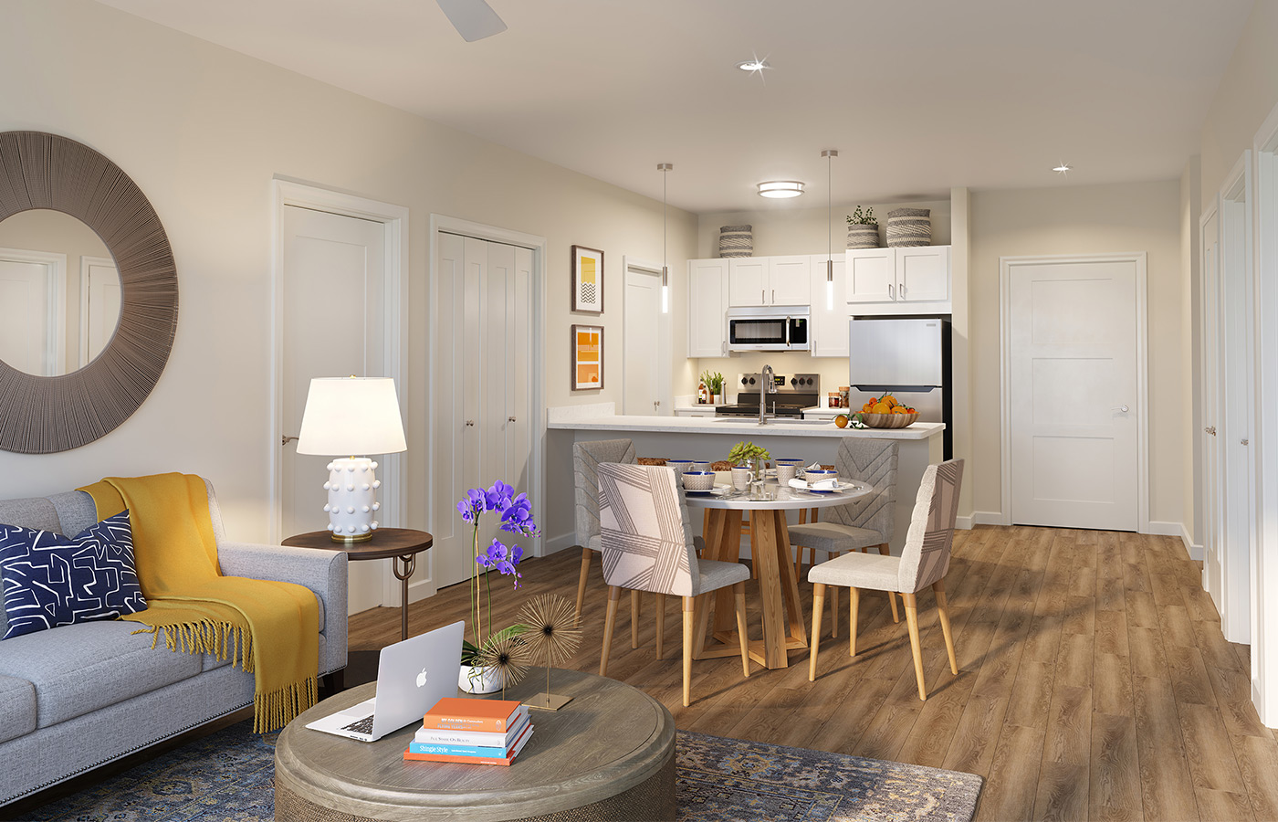 Fully furnished model apartment featuring a furnished kitchen, dining area and living room.