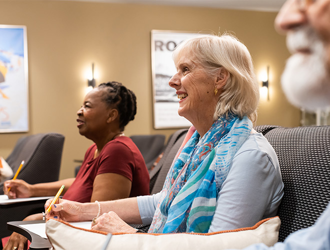People in a class taking notes.