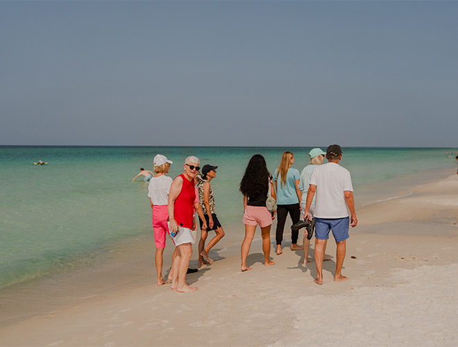 People walking on the beach.