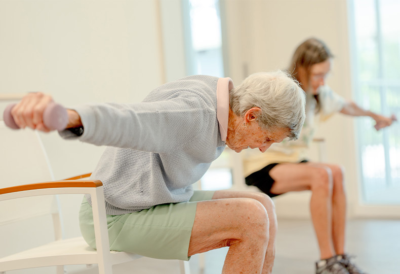 People in a seated fitness class.