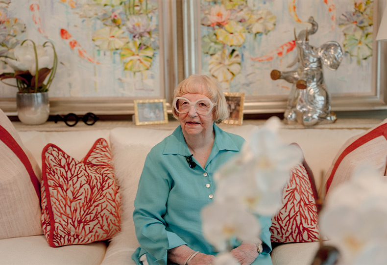 A person sitting on the couch smiling.