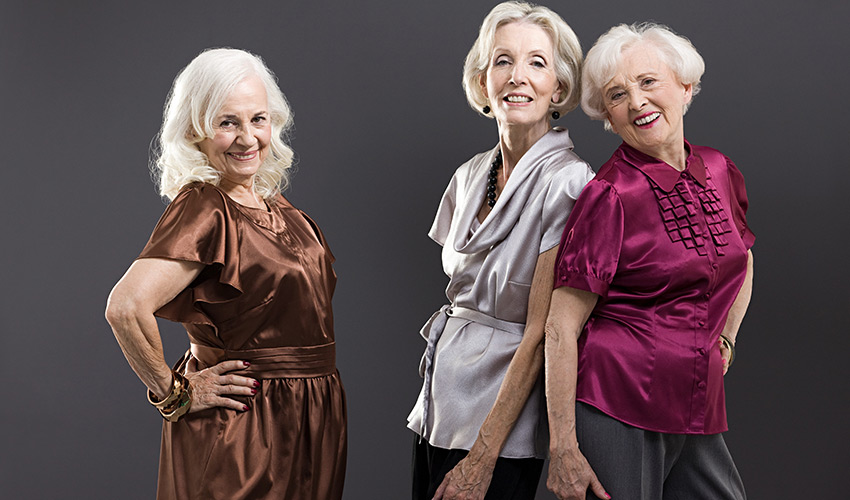 Three persons posing for fashion show.