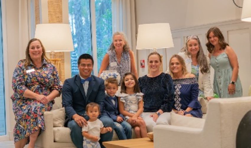 A large group of people sitting and smiling.