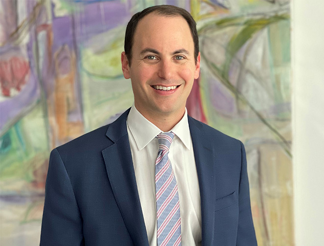 A person standing and smiling.