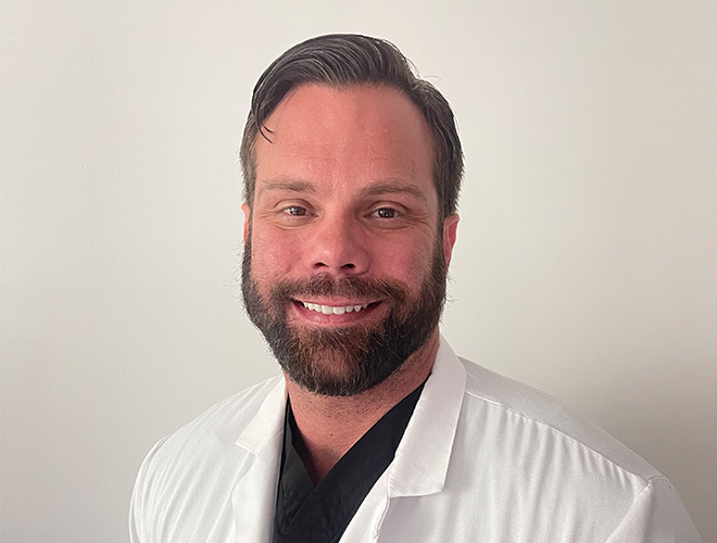 A doctor in a white jacket.