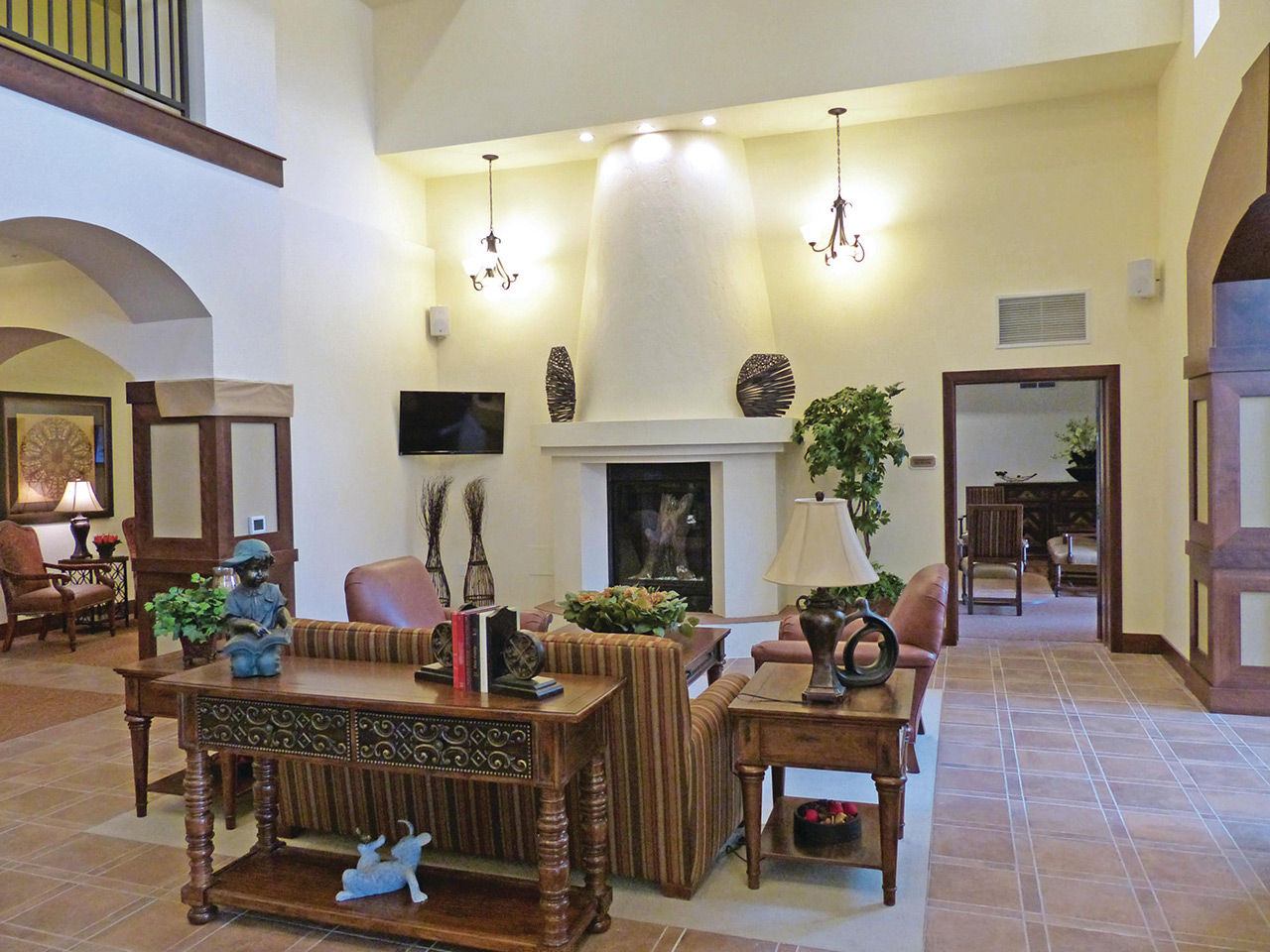 large decorated living area with seating and a fire place