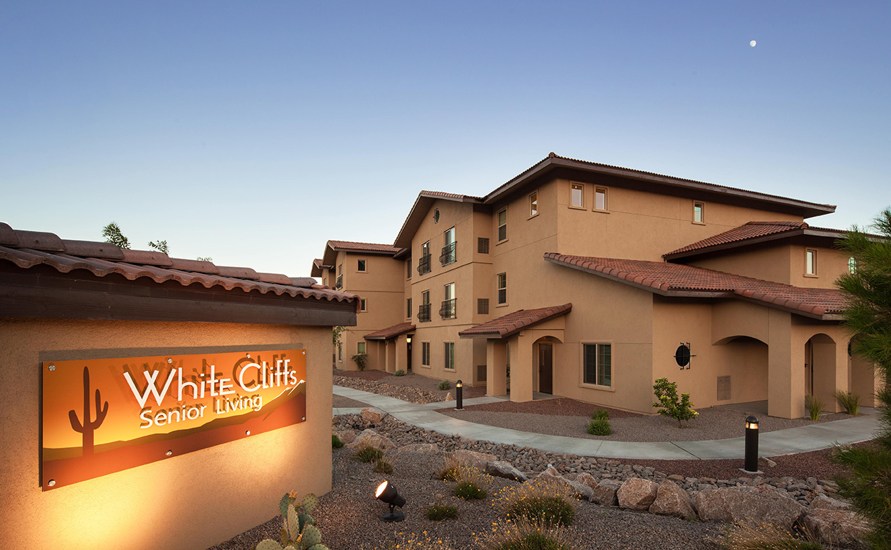 The entrance to White Cliffs Senior Living at sunset.