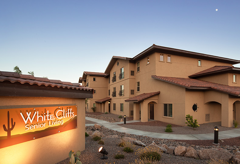 The entrance to White Cliffs Senior Living at sunset.