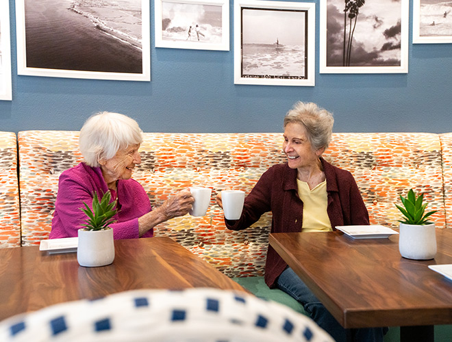 Two residents are having coffee.