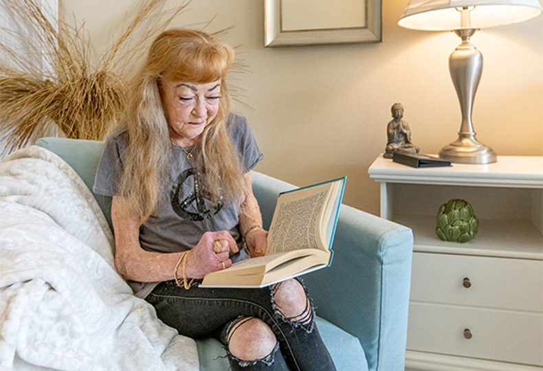 A resident sitting down and reading a book.