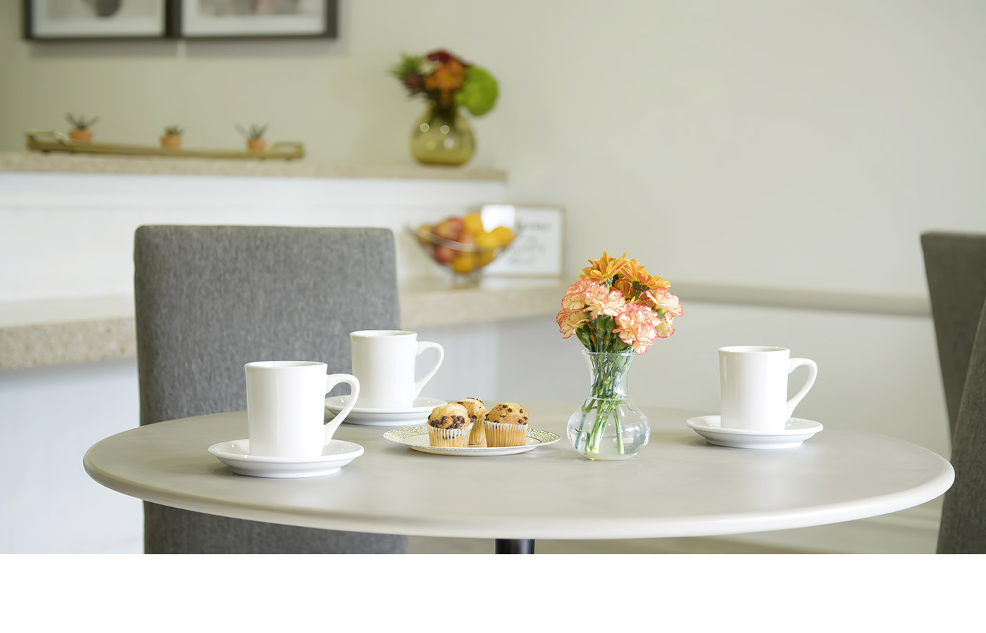 coffee cups and flowers on dining table