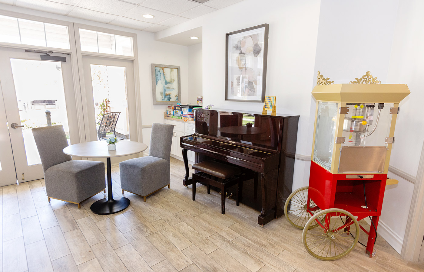 small dining table, piano and popcorn maker in bright room