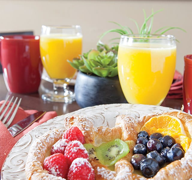 Danish with fruit and glasses of juice.