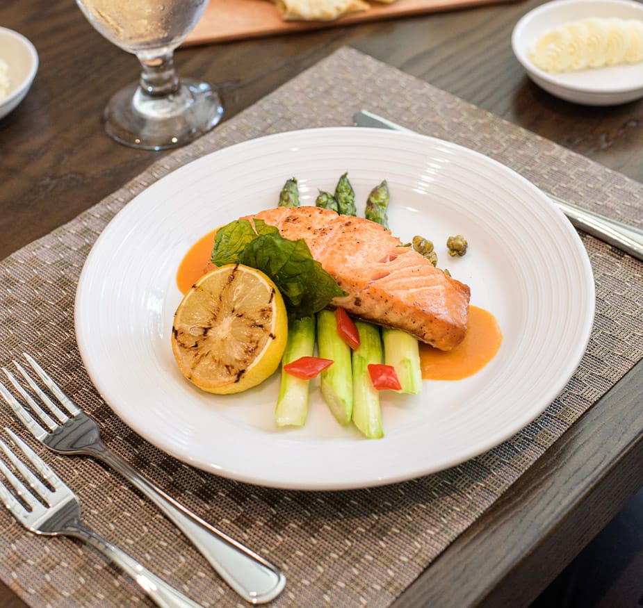 Artistic display of salmon and vegetables on a plate.