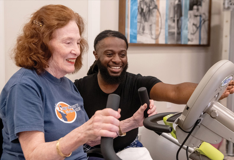 Trainer orienting resident on fitness practice.