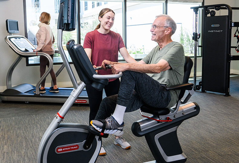 Resdient working out with a trainer.