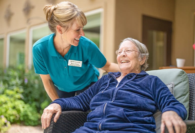 Smiling resident with an associate.