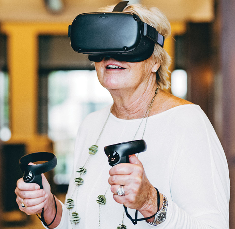 Residents enjoying virtual reality wearing goggles and holding controls.