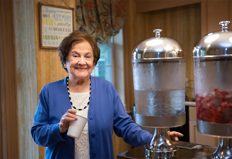 A smiling resident near a water fountain.