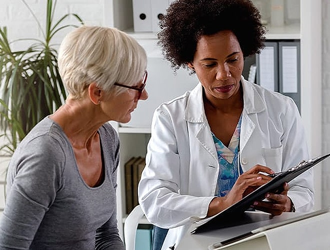 Resident talking with their nurse.