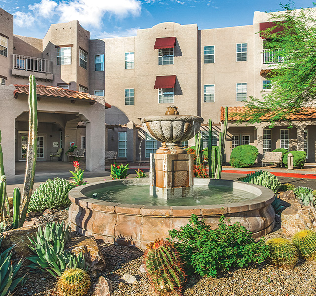 A building with a fountain in front.