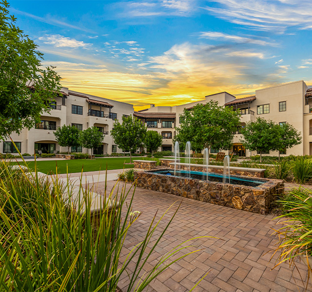 A building with a fountain in front.
