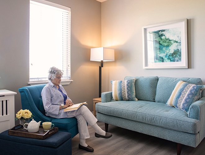 A resident is in their apartment reading.