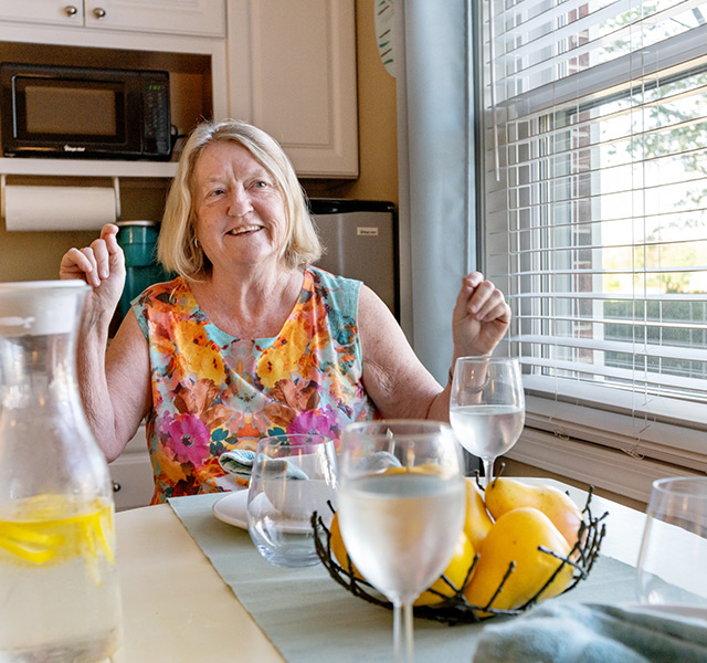 A resident is in a dining area.